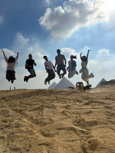 Friends celebrating and jumping with joy in Egypt