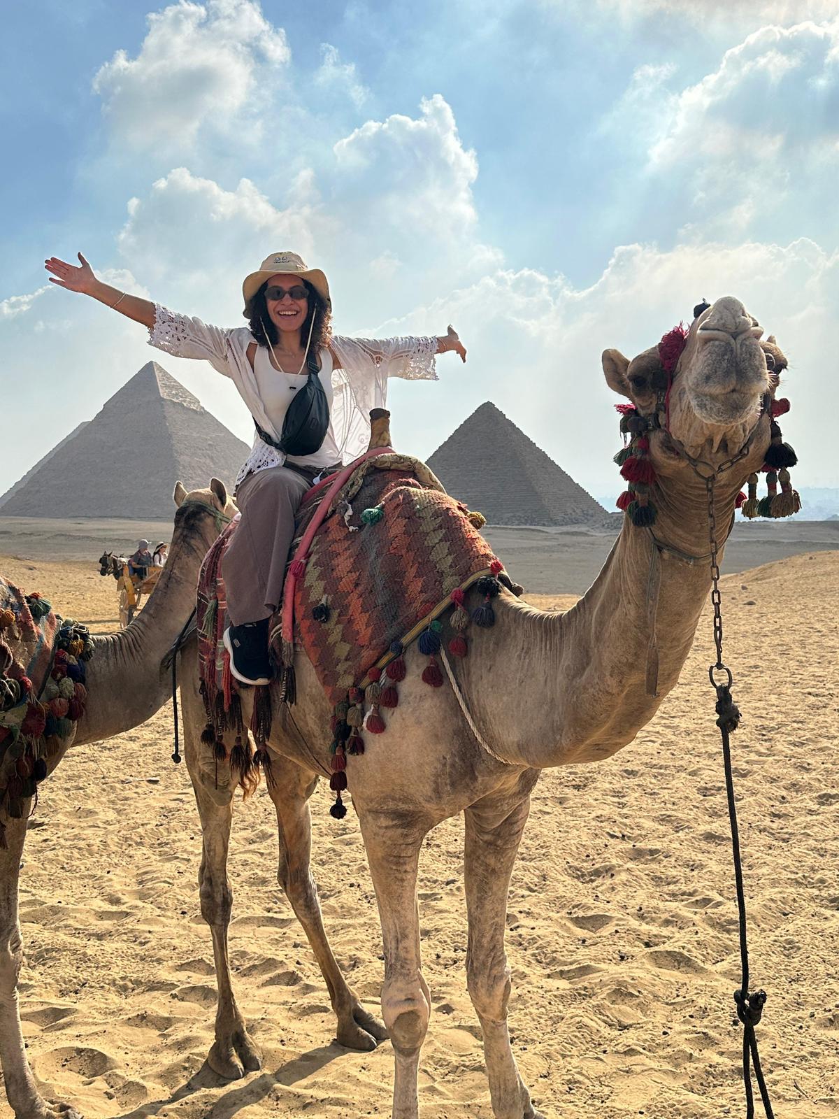 Young traveler enjoying a camel ride in the desert